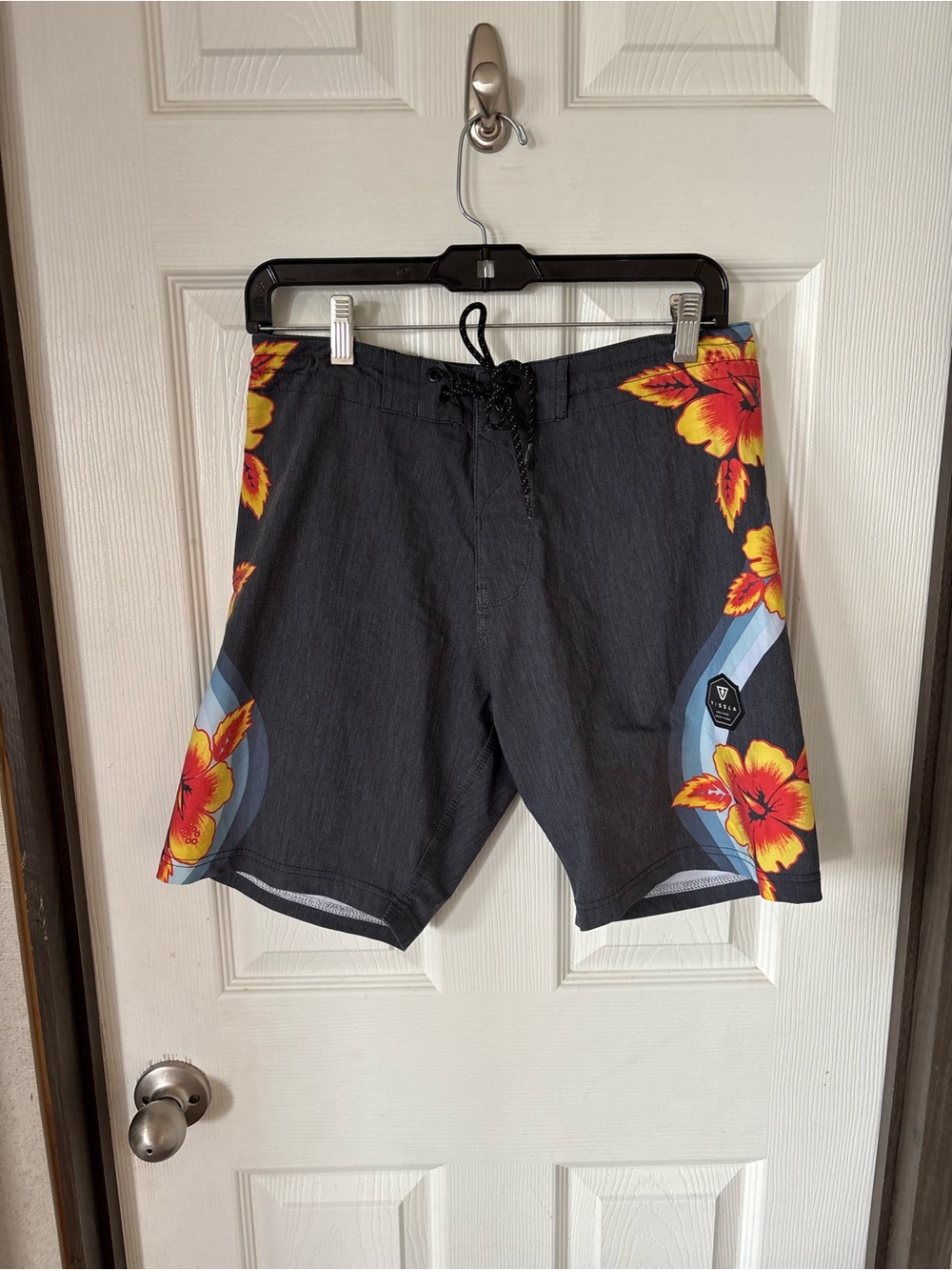 VISSLA Black Boardshorts with Yellow-Orange Floral Accents